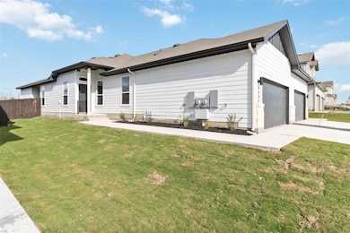 Rear view of property featuring concrete driveway