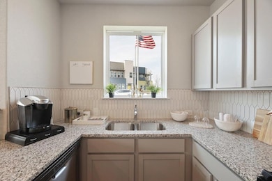 Kitchen featuring a sink, backsplash, dishwasher,