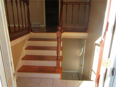 Gleaming entry with original hardwood stair treads and newer ceramic tile is very welcoming!