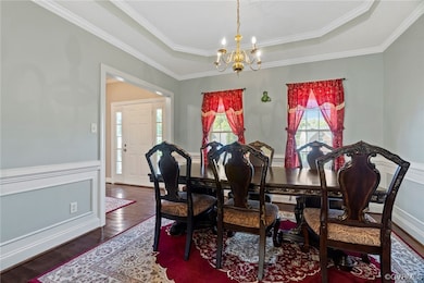 Dining space with ornamental molding, a raised cei