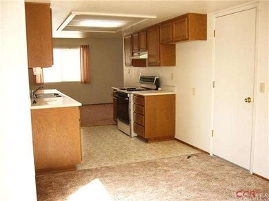 Kitchen viewed from dining area to family room