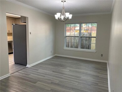 DINING ROOM WITH NEW FIXTURE AND CROWN MOLDING.