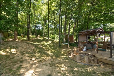Shaded, private and fenced back yard boasts a large gazebo & firepit with lots of deck space!!