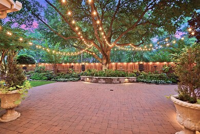Imagine if this was your backyard! Extended paver decking and glorious lights strung from the tree to the home for a truly magical setting.