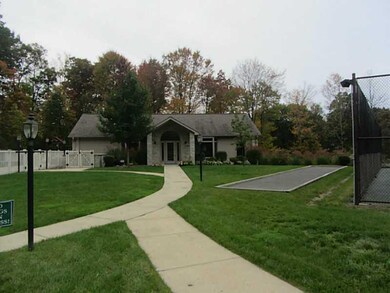Exterior Front. Clubhouse, pool to the left, bocce