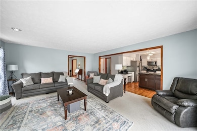 Living area featuring a textured ceiling and light wood-style flooring