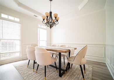 Dining room featuring a chandelier, dark wood-styl