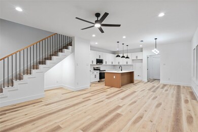 Kitchen with open floor plan, light wood finished 