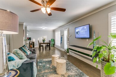 Living room featuring ceiling fan, dark wood floor