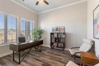 The home office overlooks the front porch. Notice the crown molding around this room, and the wide baseboards.