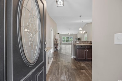 Entryway featuring baseboards, dark wood-style flo