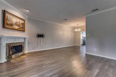 Living room featuring wood flooring, a stone firep