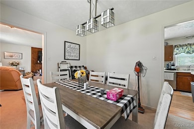 Dining space with a textured ceiling and light car