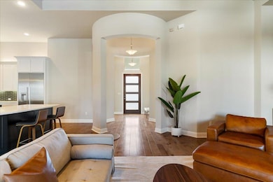 Living room with arched walkways, recessed lighti