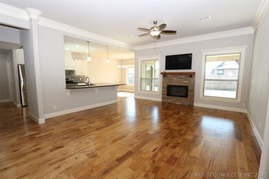 Cozy stone fireplace in family room, plus TV above