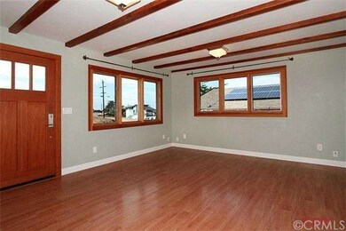 Living room with beamed ceiling and Marvin windows