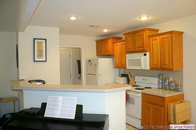The kitchen has ample work space and tile floor. T