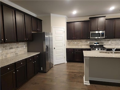 Kitchen with a sink, stainless steel appliances, d