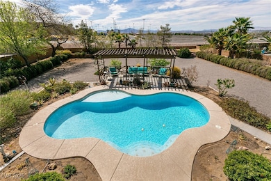 View of swimming pool with fence and a patio area,