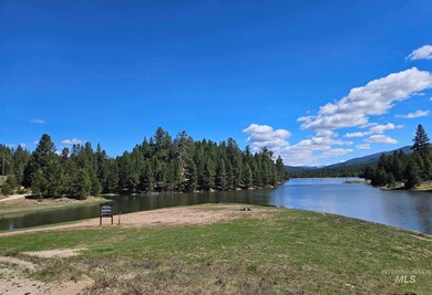Water view with a heavily wooded area and a mountainous background