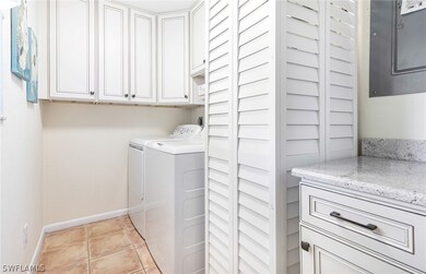 Washroom featuring cabinets, washing machine and d