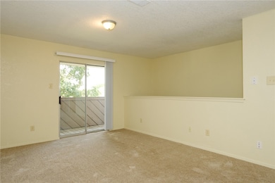 Carpeted empty room with a textured ceiling