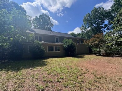 Rear view of property featuring a lawn