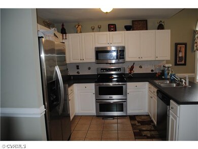 Kitchen - Tons of counter/cabinet space. Ceramic tile floor. Chair rail.