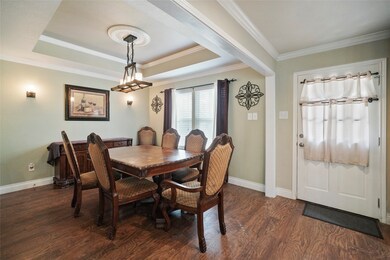 Spacious Formal dining room has tray ceiling and overlooks private back yard