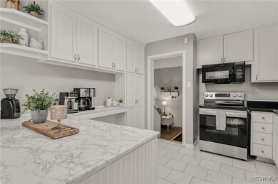 Kitchen featuring black microwave, stainless steel