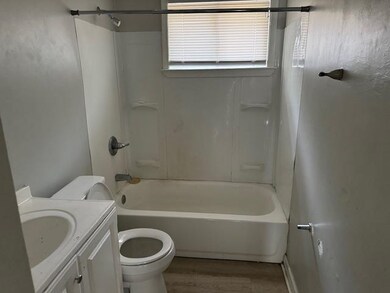 Full bathroom with hardwood / wood-style flooring,