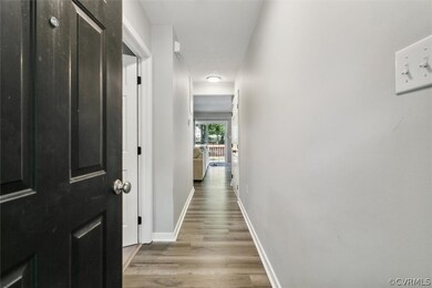 Hall with hardwood / wood-style floors