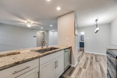 Kitchen with pendant lighting, white cabinets, sin