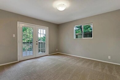 Unfurnished room featuring french doors, baseboar
