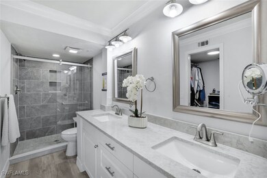 Primary bathroom with vanity, toilet, crown moldin