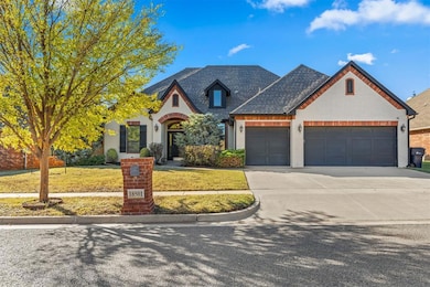 View of front of house featuring brick siding, a garage, driveway, and a front lawn