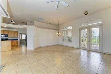 Foyer, full-glass double doors opening to elegant formal living and dining spaces.