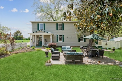 Side view of house featuring an outdoor hangout ar