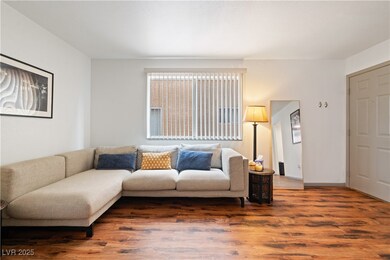 Living area with baseboards and wood finished floo