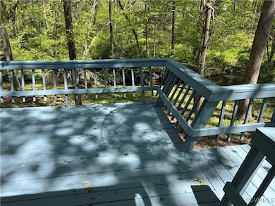 Wooden deck featuring a wooded view