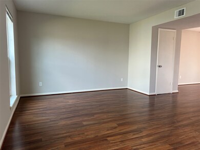 The living room has a large opening which flows ea