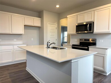 Kitchen with white cabinets, stainless steel appl