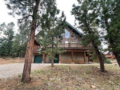 Log-style house with a garage and a deck