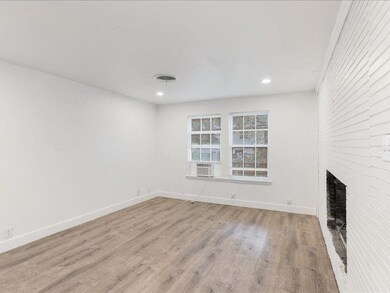 Unfurnished living room with a fireplace and light hardwood / wood-style flooring