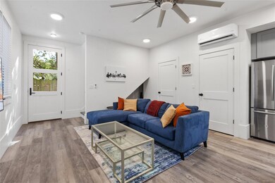 Living area featuring a wall mounted AC, a ceilin