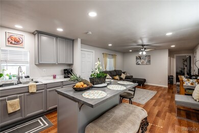 Kitchen featuring ceiling fan, gray cabinets, a br