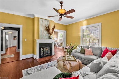 Living room off the foyer and dining room with cozy fireplace.