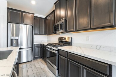 Kitchen with stainless steel appliances, dark brow