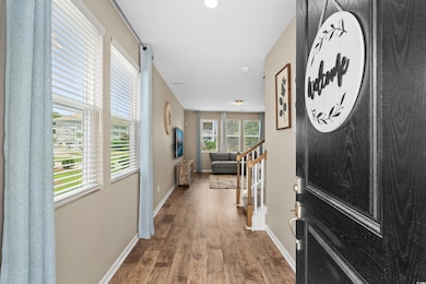 Entryway with wood finished floors and baseboards