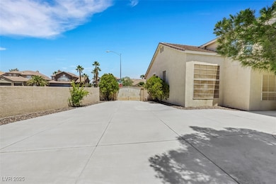 Backyard with side gate and concrete throughout
